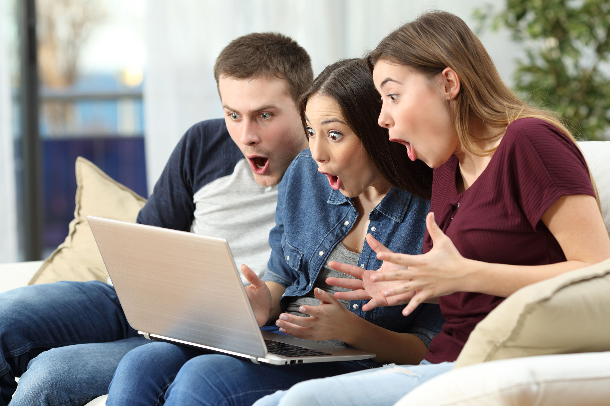 People amazed watching content on laptop